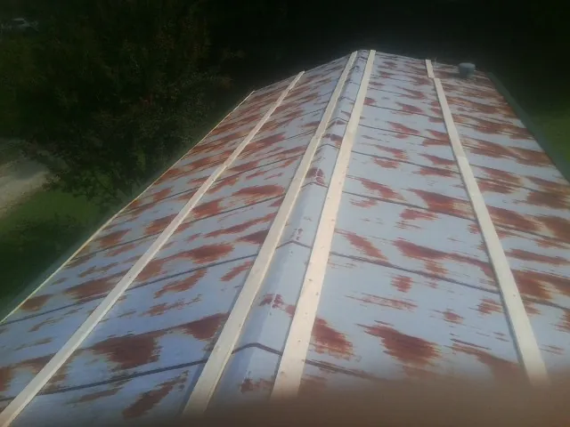 Rusted metal roof panels with new wood purlins before replacement — Storm Damage Roof Repair in Yoncalla by Roofing Brothers